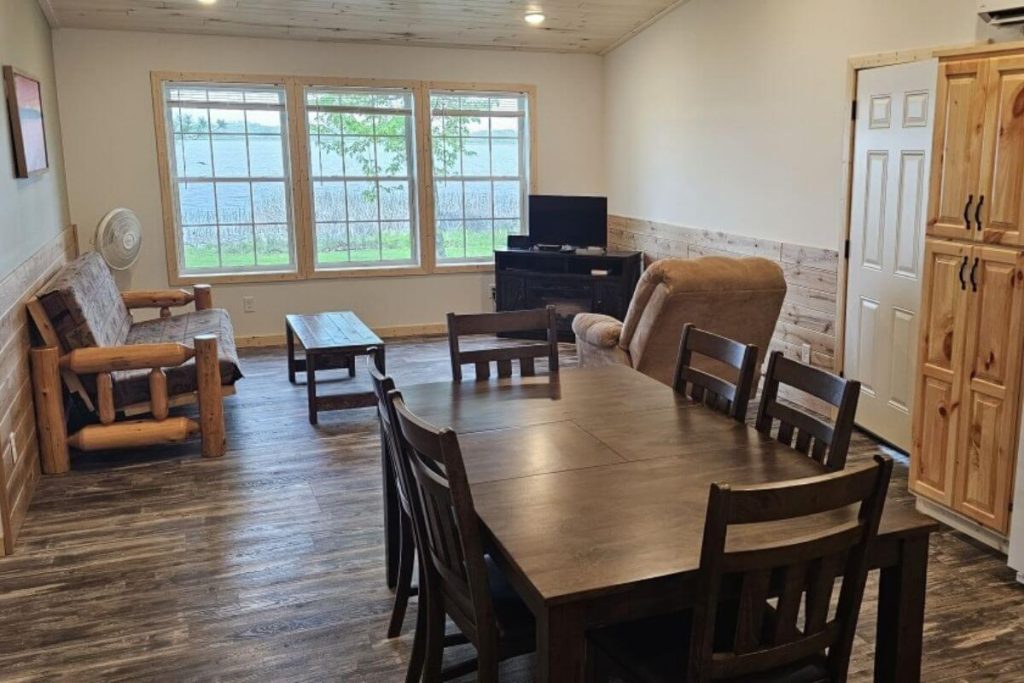 Cabin #6 - Dining Area and Living Room with Log Futon Couch and Lakefront Views