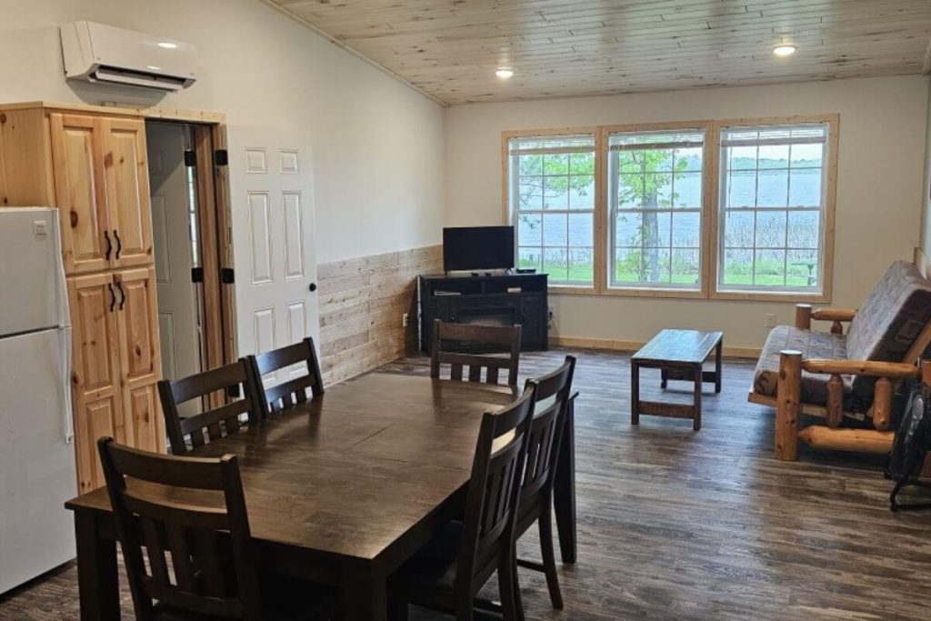 Cabin #7 - Dining Area and Living Room with Log Futon Couch and Lakefront Views