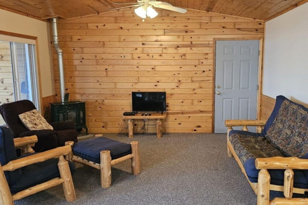 Cabin #16 - Living Room with Log Futon Couch and Gas Fireplace