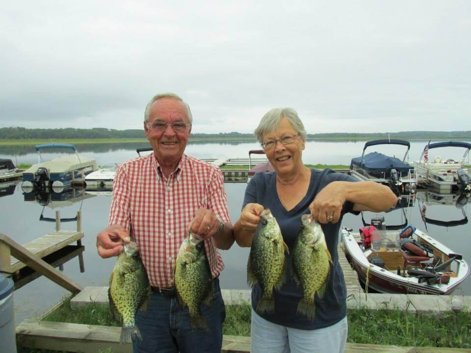 An Eldery Couple Holds Up Their Cass Lake Catch of the Day
