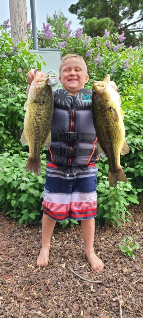 Proud Young Fisherman Holds Up His Cass Lake Walleyes