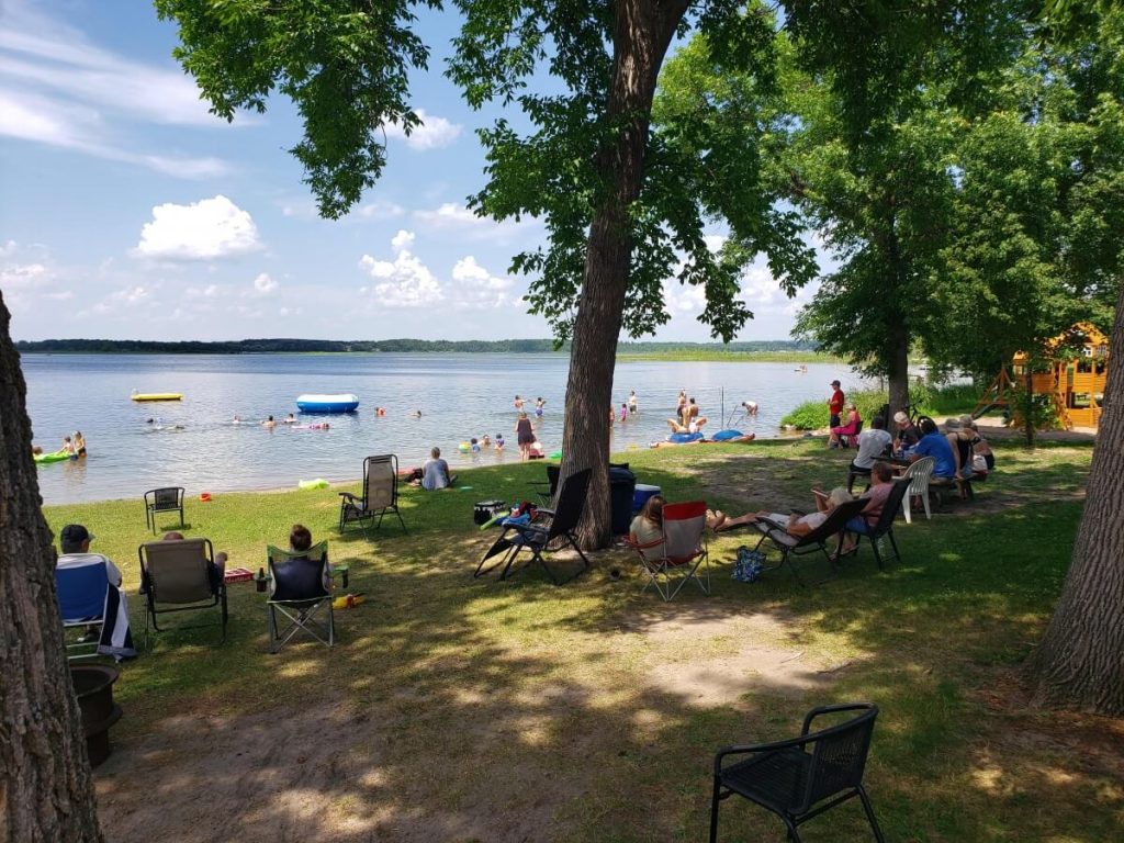 Sunset Cove Resort Guests and Patrons Enjoy a Sunny Day on the Sandy Beach