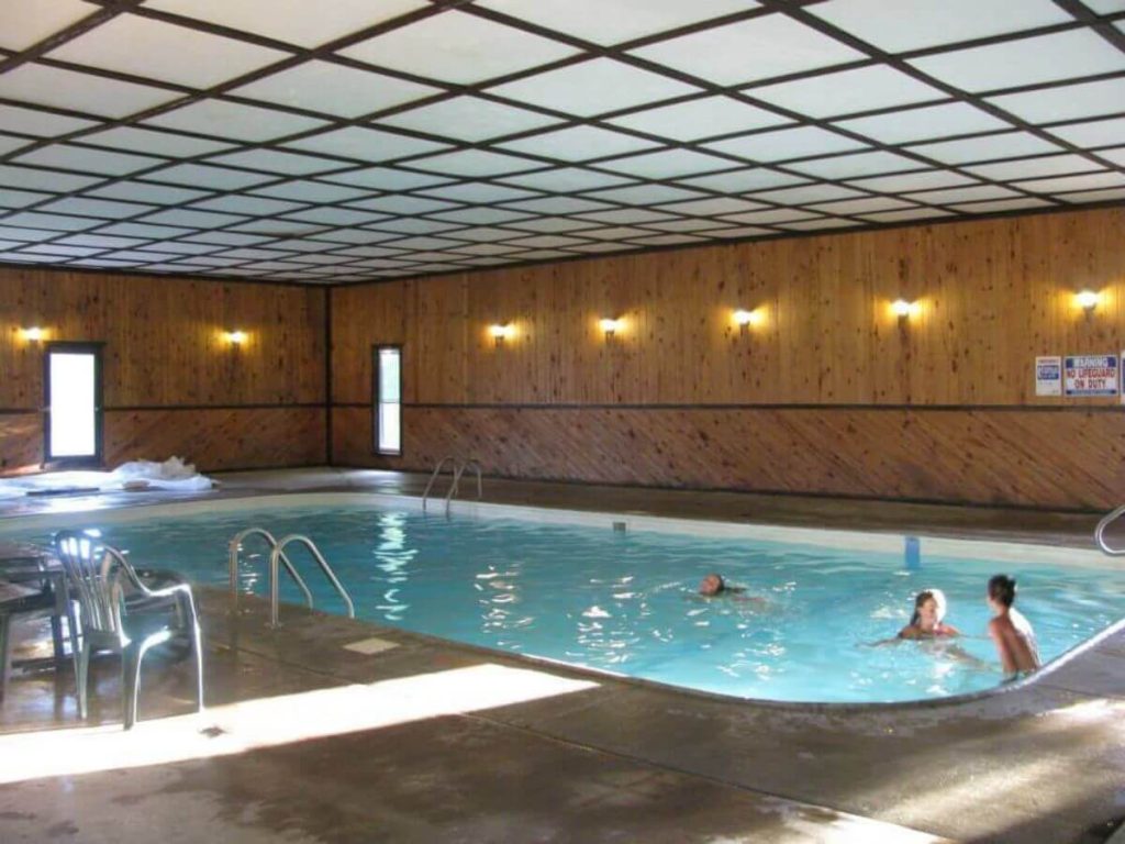 Young Resort Guests Enjoy Swimming at Sunset Cove Resort's Indoor Heated Swimming Pool